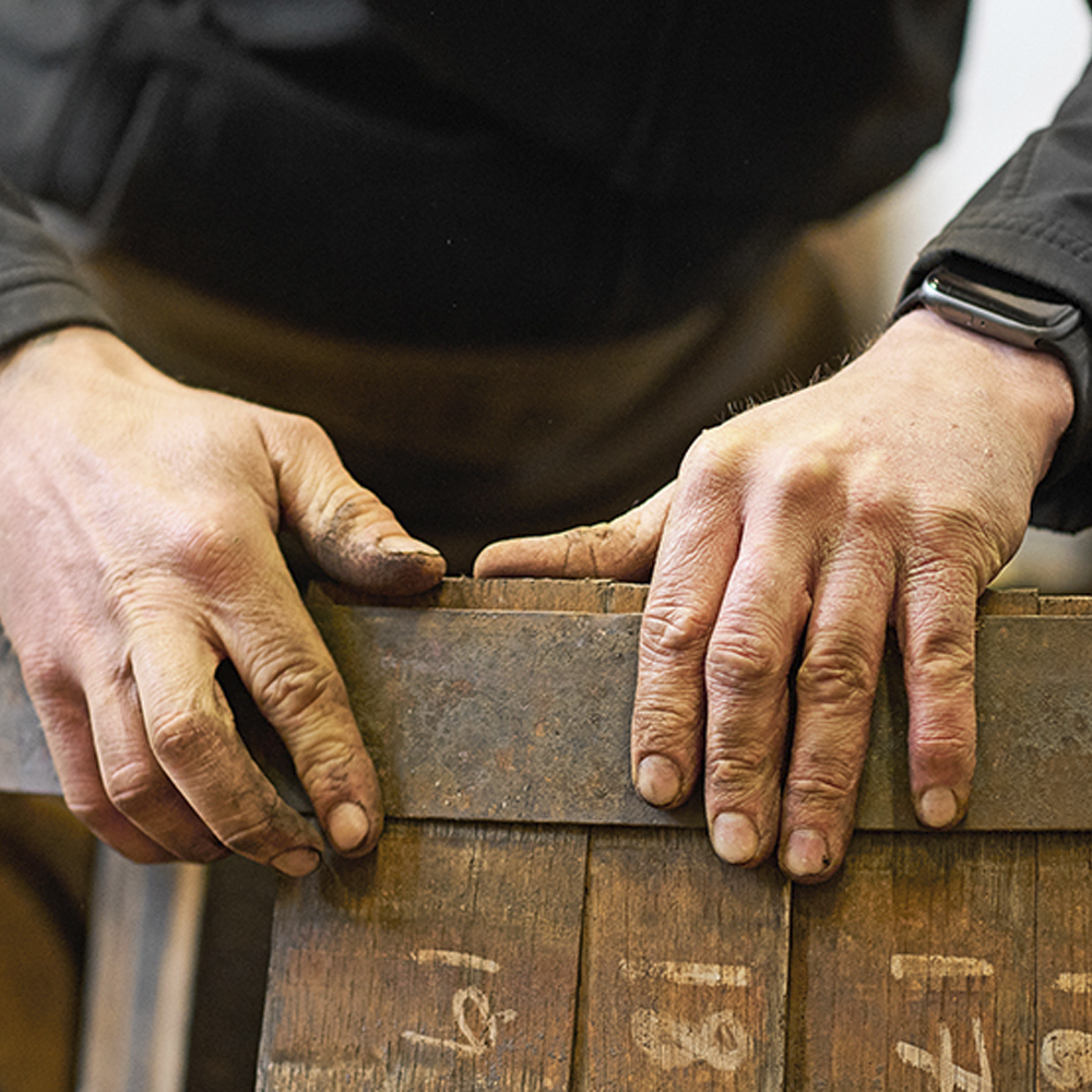 man holding whisky barrel