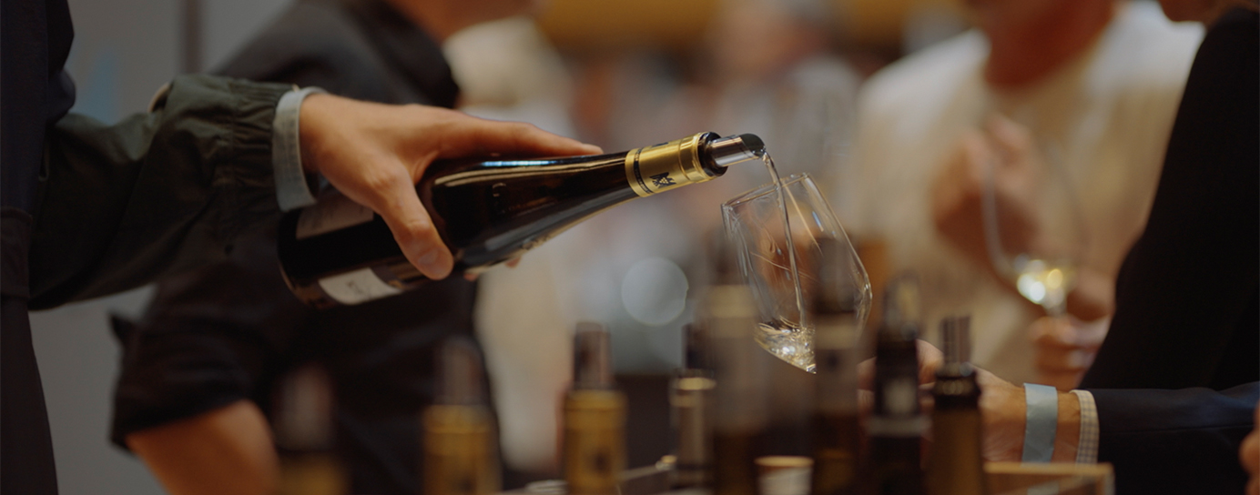 Person pouring wine into a glass
