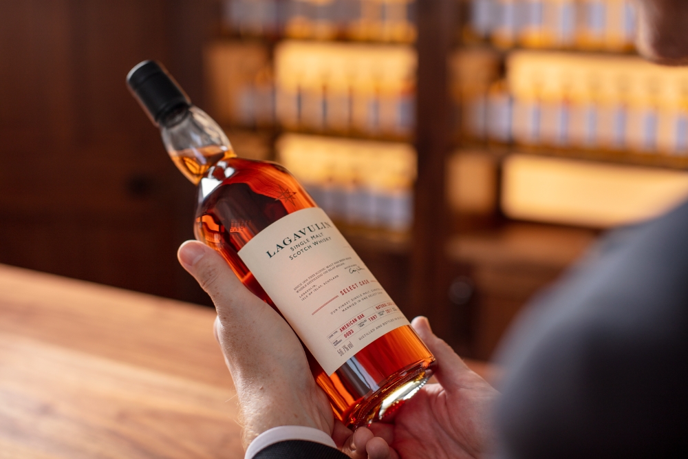 Whisky Bottle in Persons Hand