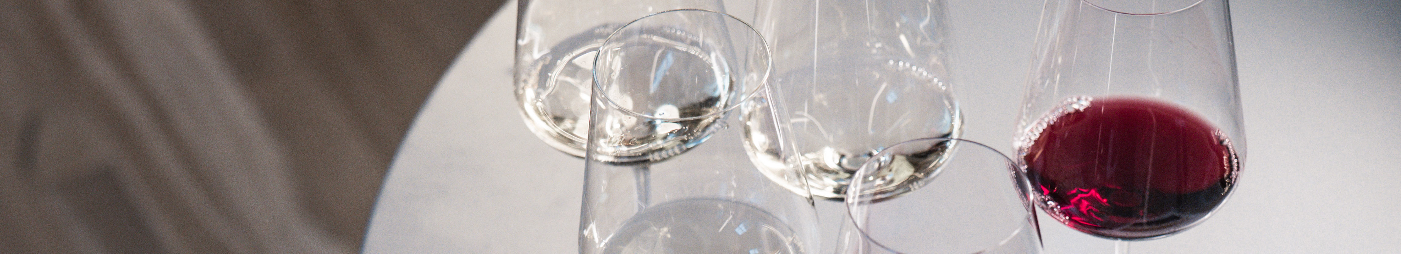 dark image of wine bottle glass with a red shape