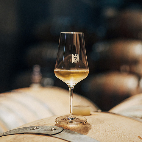 Riesling wine on top of a wine barrell