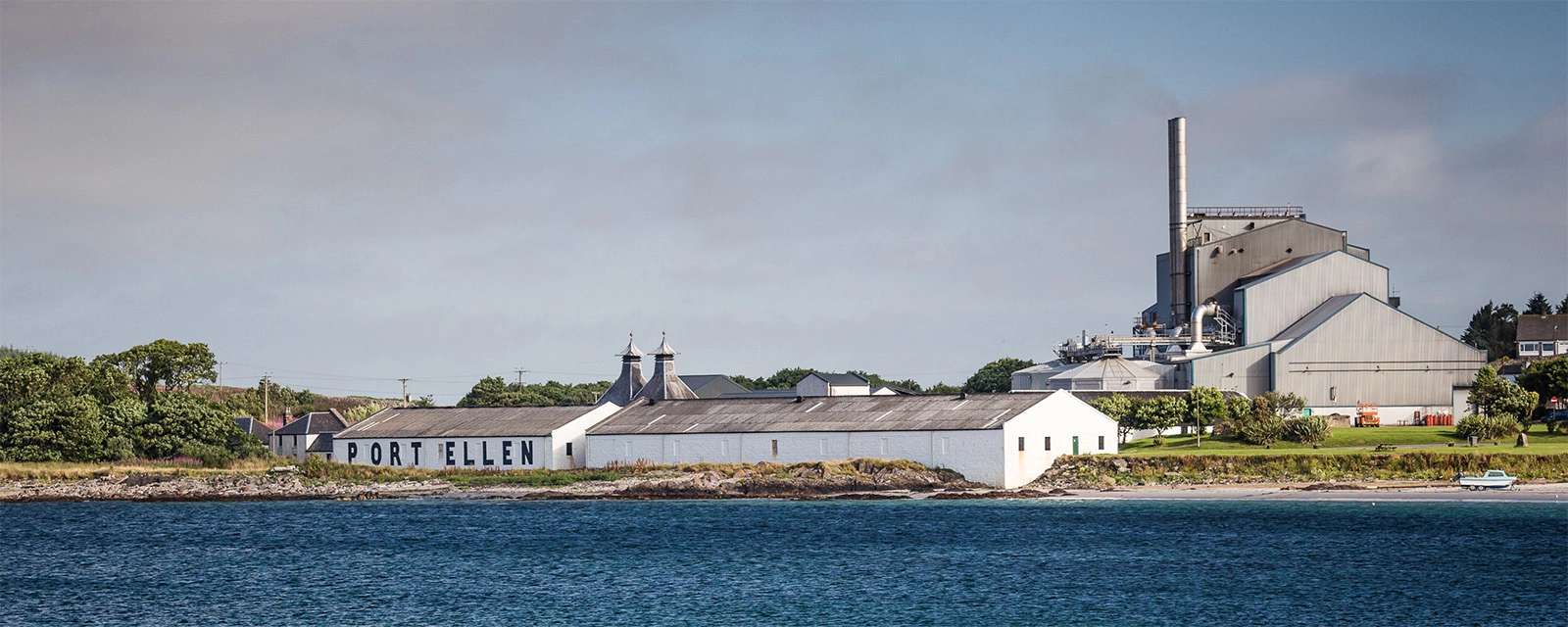 port ellen distillery with ocean in the foreground