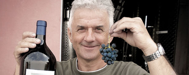 Man holding grapes and wine