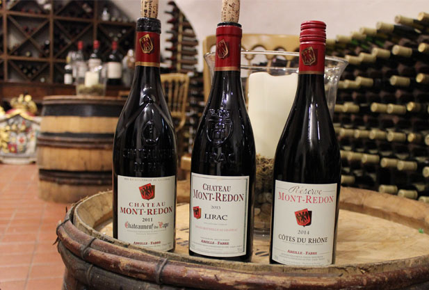 three bottles of wine with cellar in background