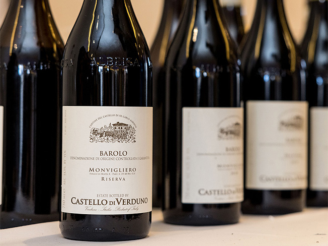 Several bottles of Riserva Wines in a row on a white table