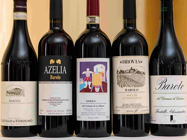 Rows of different Barolo wines on a white table