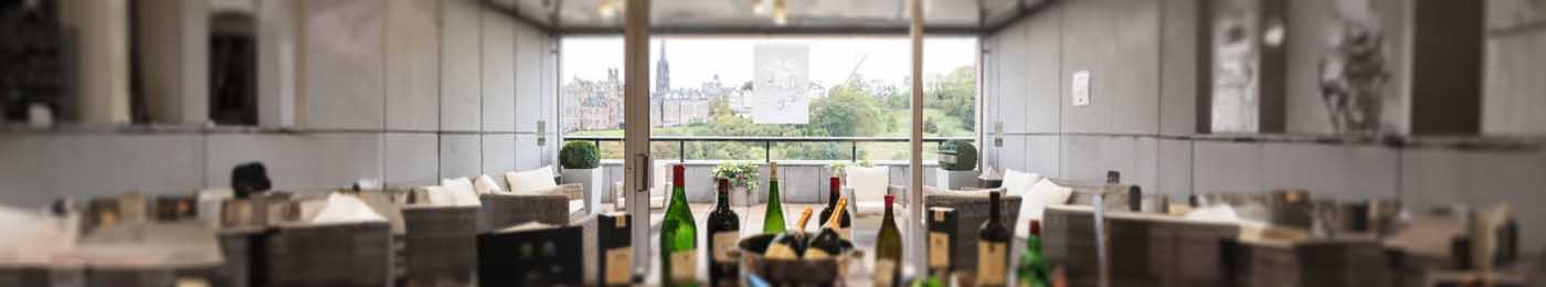 bottles on a table with large window behind