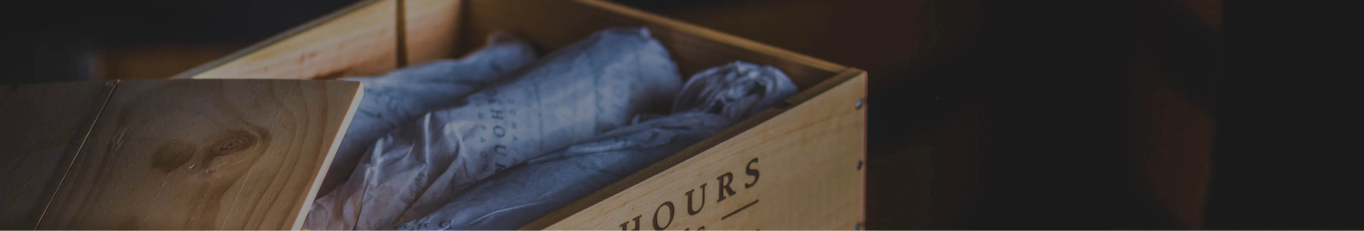 row of wine bottles with different coloured labels.