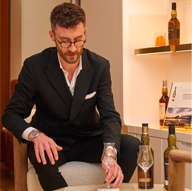 Ethan holding a glass of whisky in Burlington Arcade