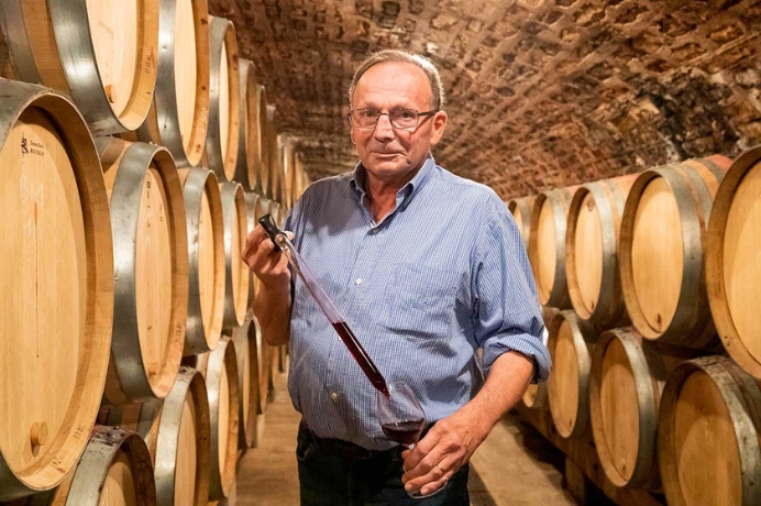Bruno clair in front of barrels.
