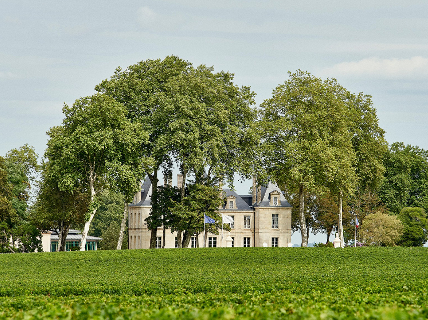 CHÂTEAU PICHON COMTESSE sits behind tall trees