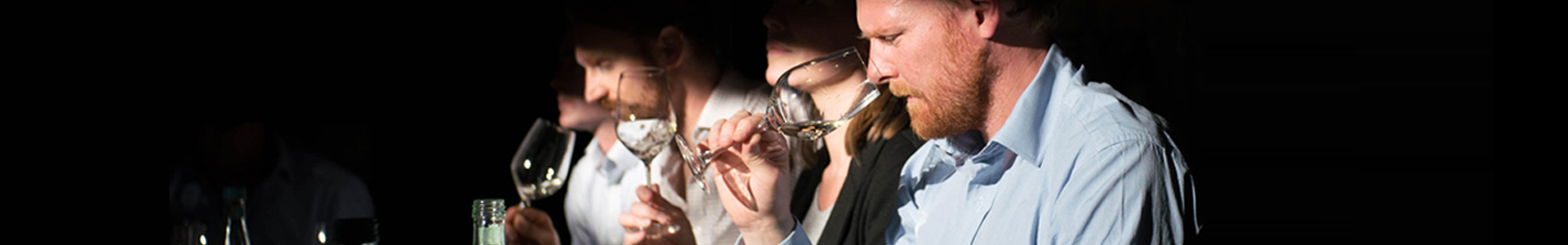 Three people having a wine tasting
