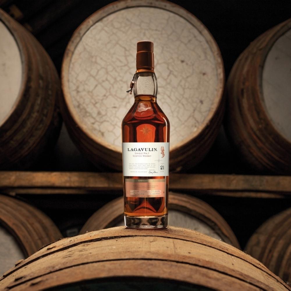 bottle of whisky on wooden casks