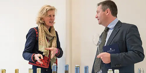 A man and a woman talking about wine