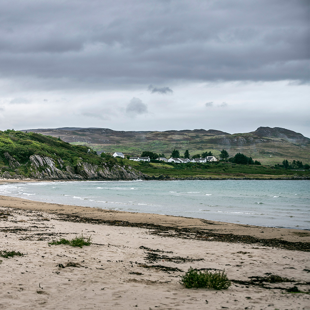 A beach with mountains on the horizon in the Isle of Islay