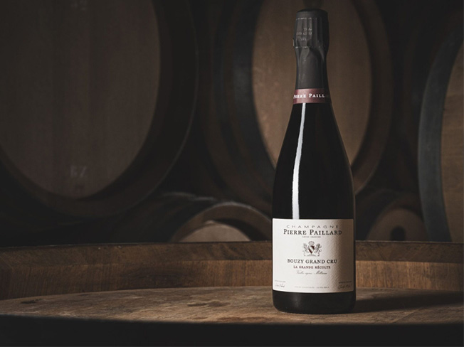 Pierre Paillard champagne bottle on top of a wine barrell