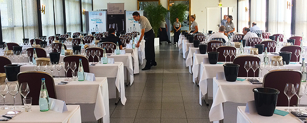 Rows of tables with wine glasses on them