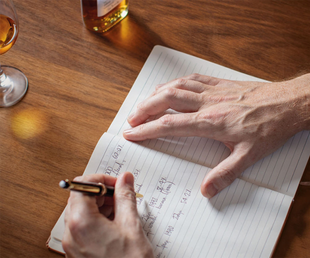 Man holding pen and writing