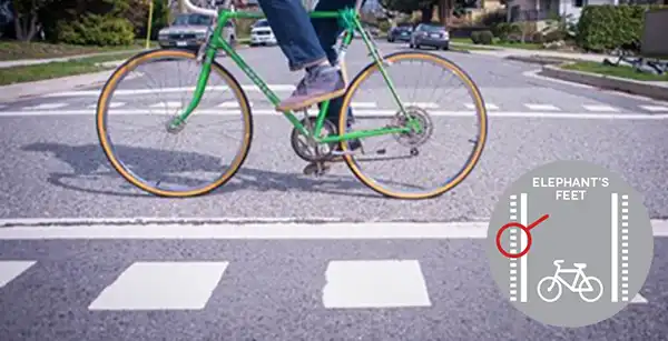 Elephant feet crossing, with bicycle in crosswalk 