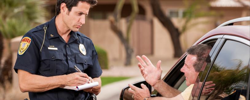 Police officer giving man a traffic ticket