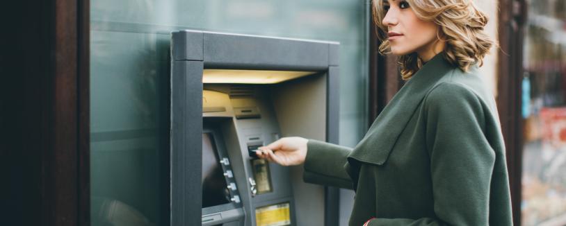 A women standing at a bank ATM