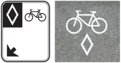 Two street signs, both with a diamond and a bicycle symbol
