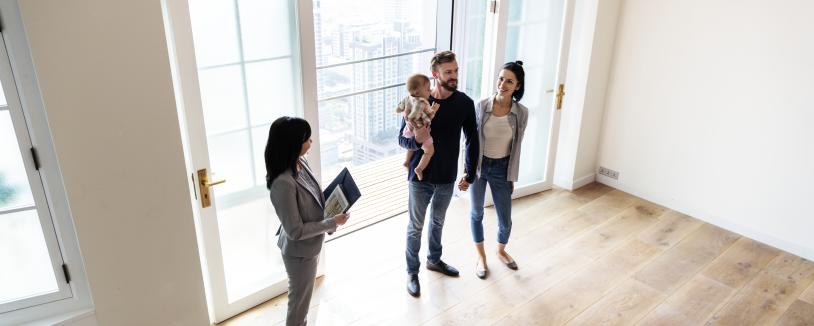 A family with a real estate agent looking at a condo