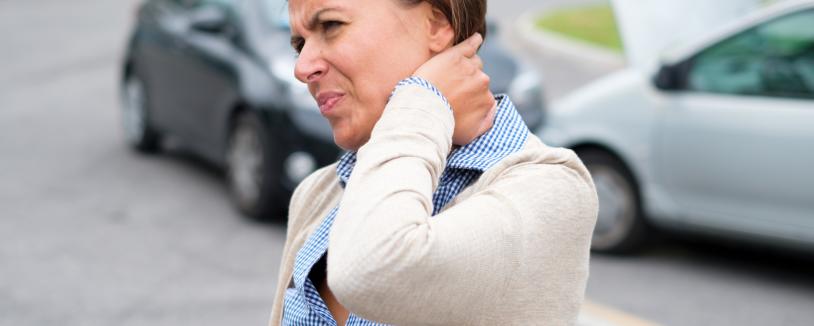 Woman holding neck after having been in an accident
