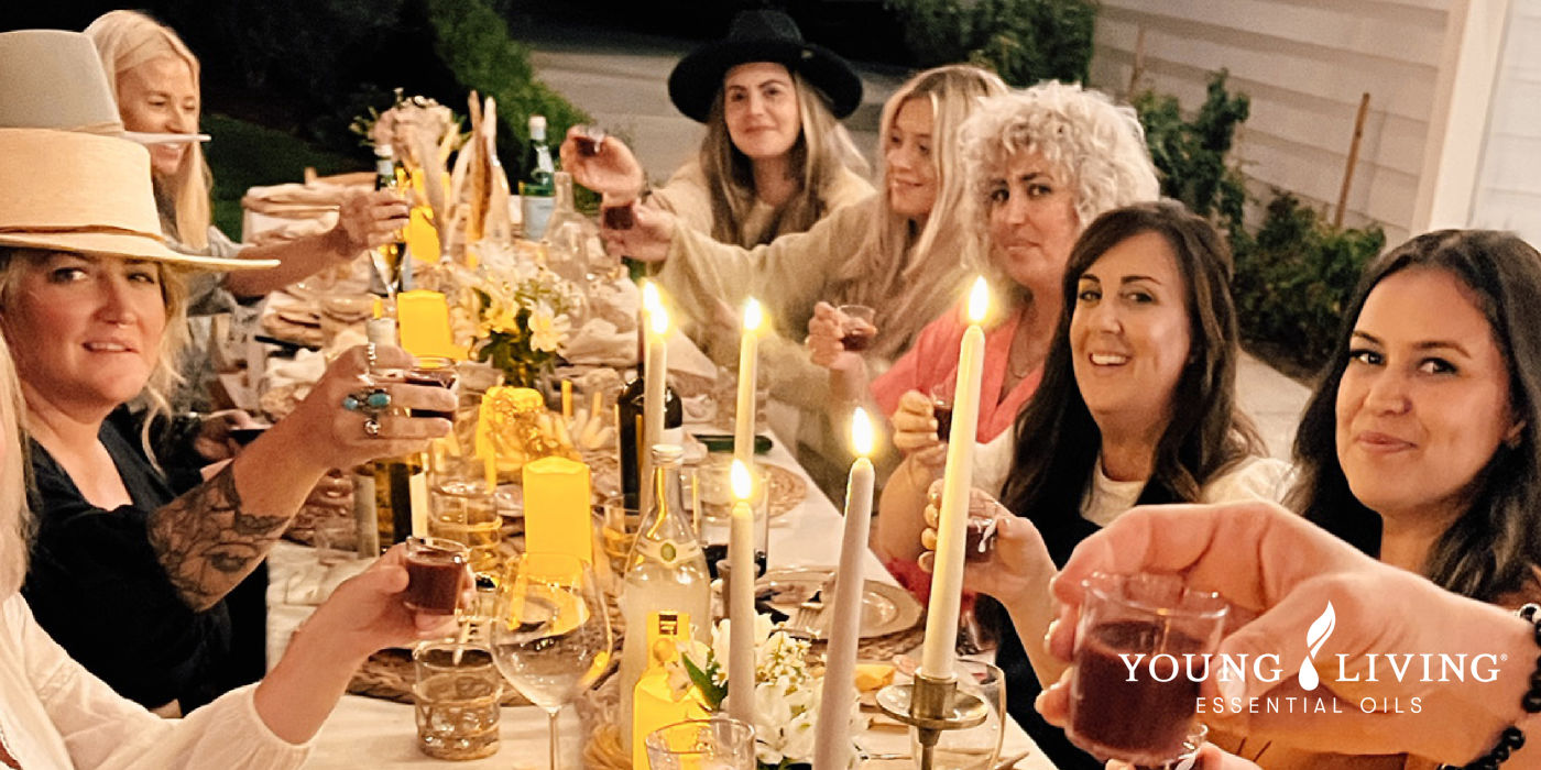 women at dinner table toasting a glass