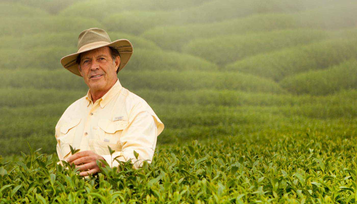 Young Living’s late founder D. Gary Young standing in a field of botanicals.