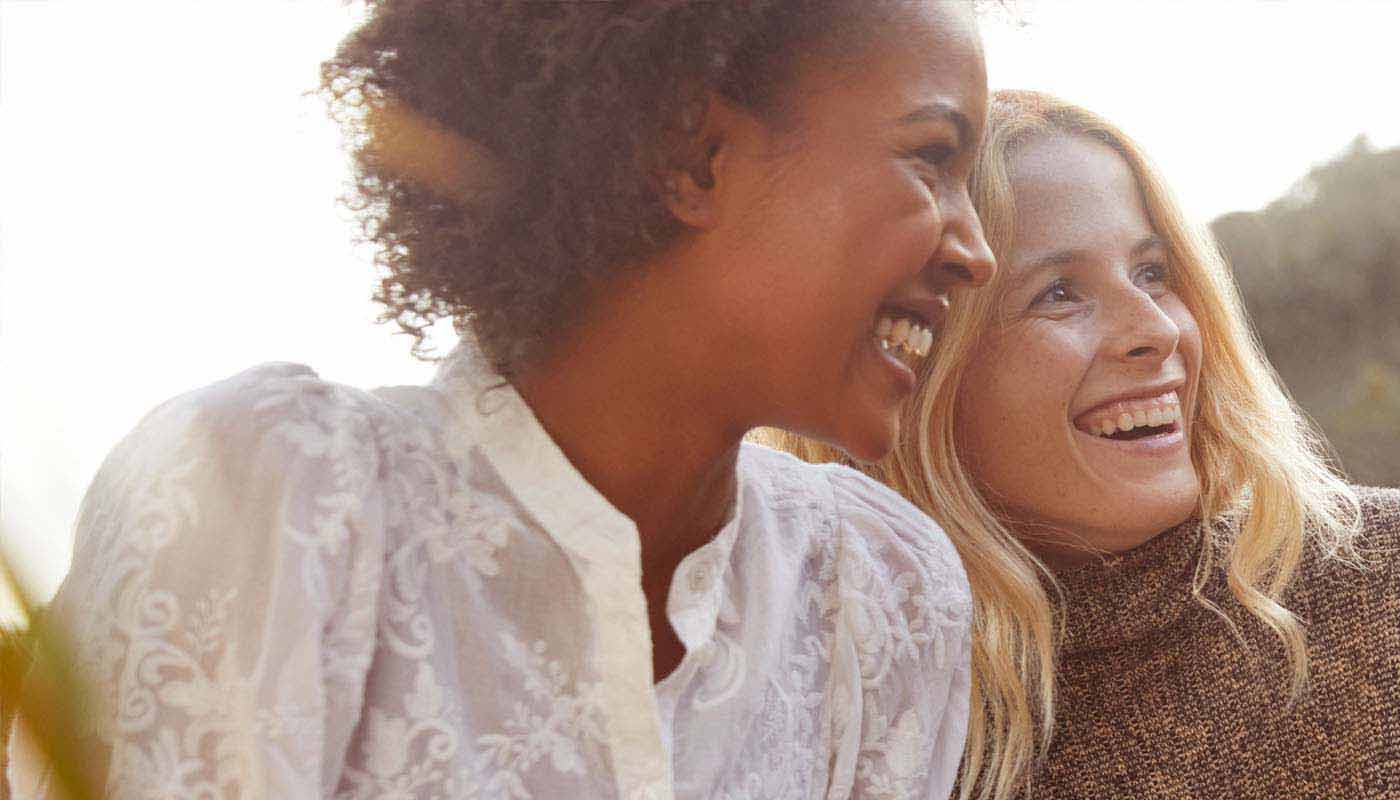 Two smiling women enjoying the outdoors.
