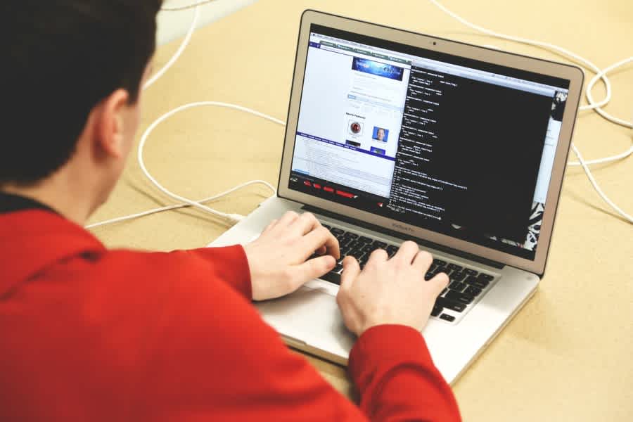 man typing on laptop