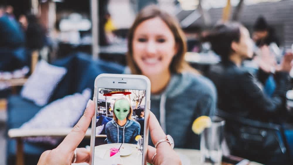 AR filter of alien face over woman's face