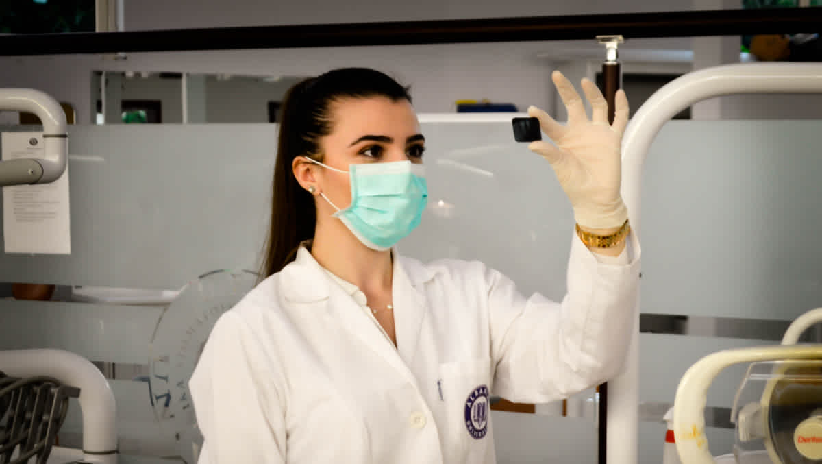 Medical researcher examines slide in the lab