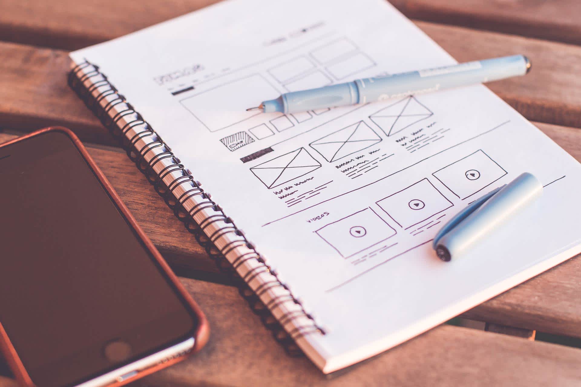 Notebook with drawings of app wireframes