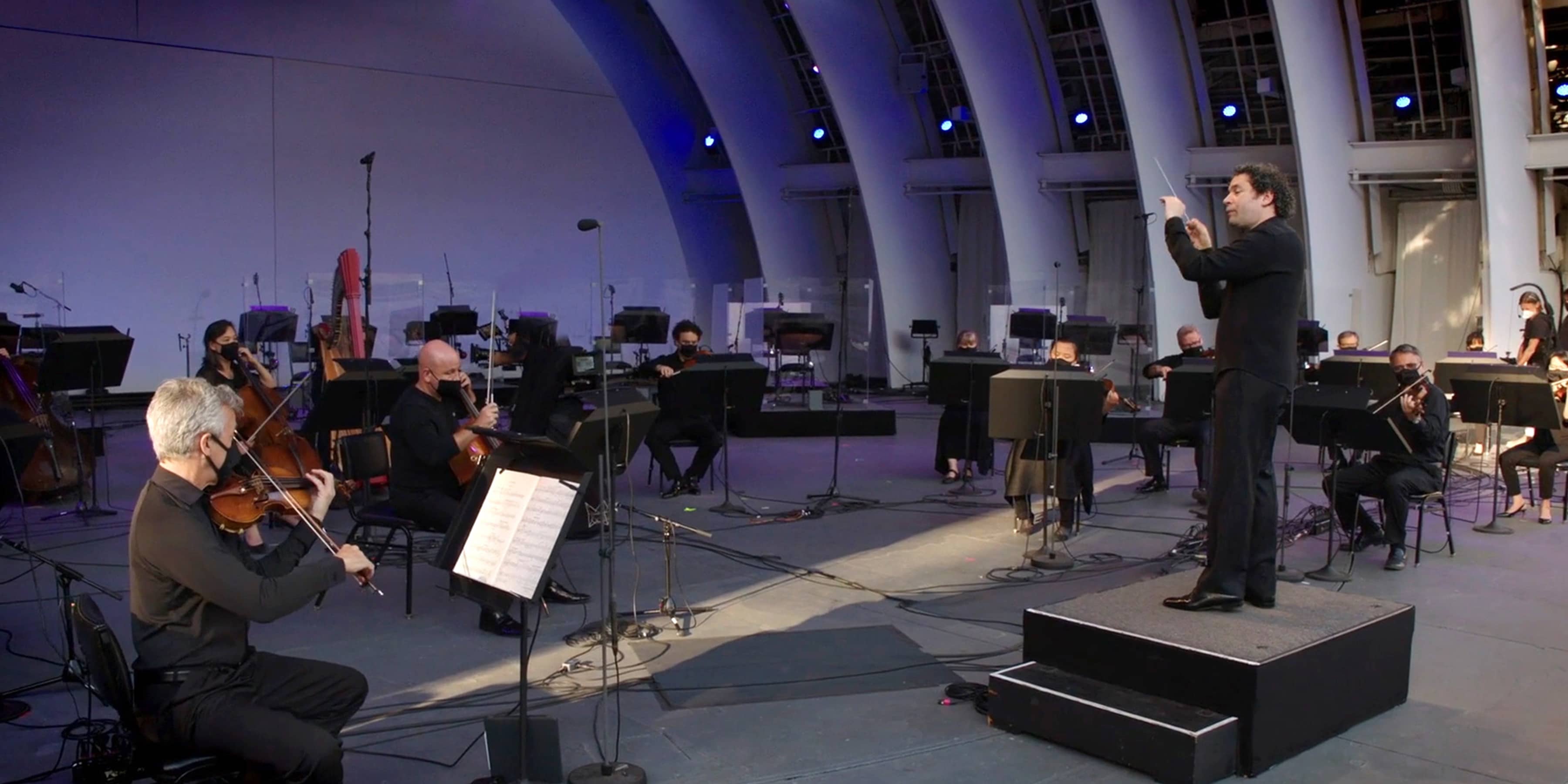The Los Angeles Philharmonic on the stage of the Hollywood Bowl, conducted by Gustavo Dudamel.