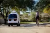 Woman bicycling in line with a Nuro vehicle