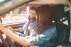 Man and woman sitting in car. 