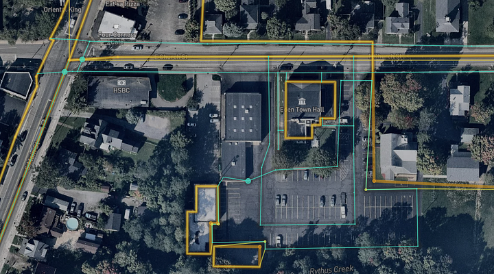 Aerial view of a city with lines detecting roads and buildings