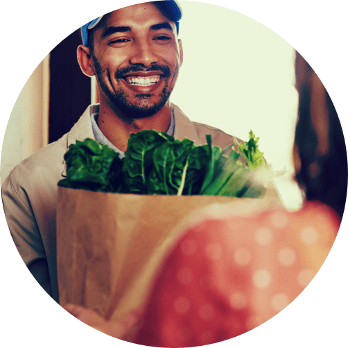 smiling man holding groceries