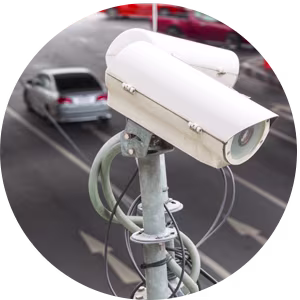 Close up of two white traffic cameras on a grey pole, pointing in different directions.