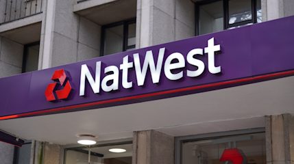 Close-up of the illuminated signage above a NatWest branch