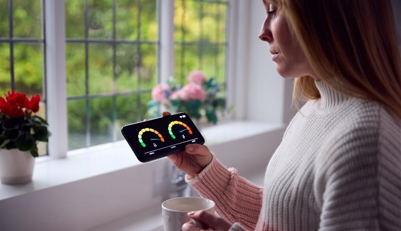 A woman looking at her smart meter.