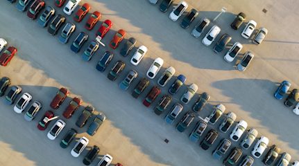 Birds-eye view of dozens of neatly parked cars