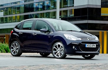A red Citroen car in an empty car park.