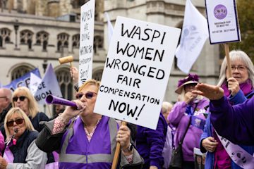 WASPI women at a campaign march with placards calling for compensation.
