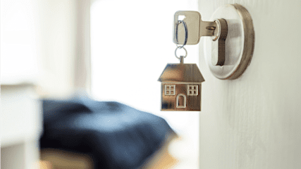 Key in lock with house-shaped keychain