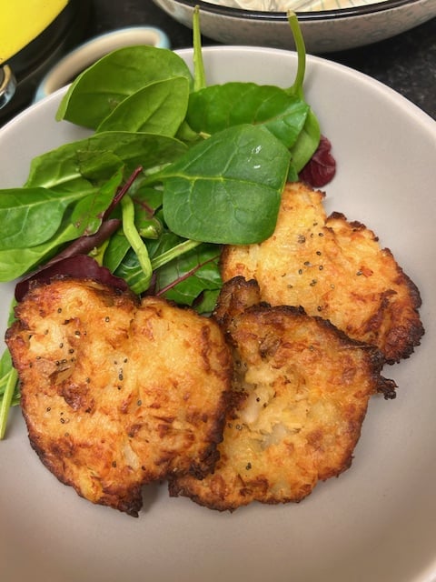 Bowl of cheesy fishcakes with salad