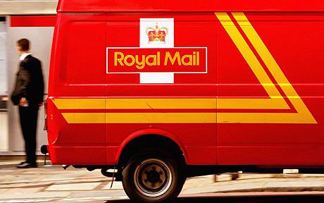 The rear of a red Royal Mail van, with someone stood in the background.