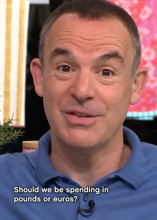 A still from Martin's video, showing a close-up of him speaking directly to camera in a studio setting. Overlaid white text reads "Should we be spending in pounds or euros?"